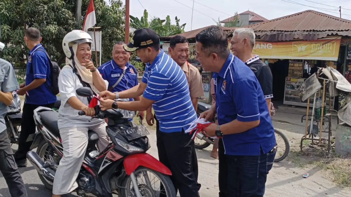 Pengurus PWI Sergai saat bagikan bendera Merah Putih ke pengguna jalan. (Fadly/Sumut Pos)