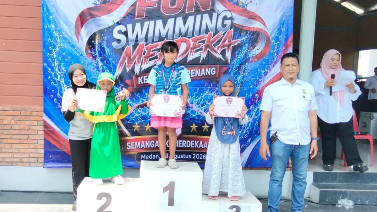 Nadira Mandalika (kiri) menerima medali dan sertifikat dari kejuaraan Fun Swimming Merdeka, di Kolam Renang Selayang Medan, Minggu (30/8/2026). (Dok: Gusman/Sumut Pos)