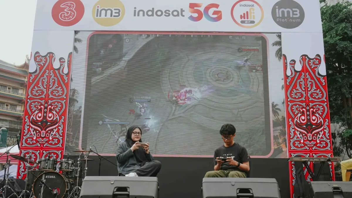 GAME: Warga saat mencoba bermain game dengan menggunakan jaringan Indosat 5G di CFD Lapangan Merdeka, Minggu (27/9/2026). (Dok: Indosat)
