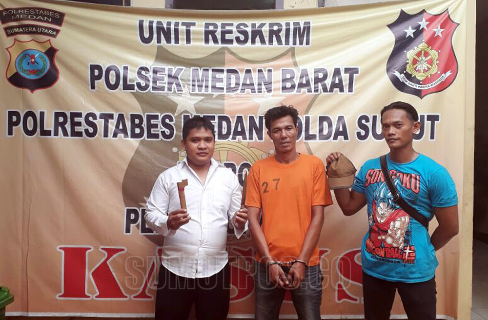 Foto: Oki/PM Kapolsek Medan Barat, Kompol Victor Ziliwu dan Kanit Reskrim Iptu Said Husen, mengapit Dayat, tersangka pelaku penikaman dan pemukulan terhadap sopir taksi, Minggu (30/7).