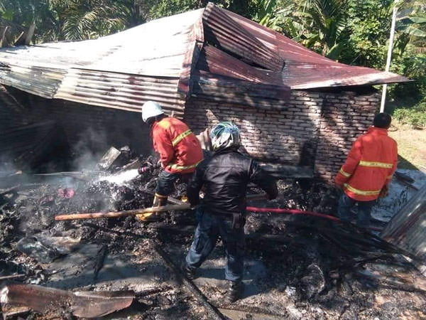 SOPIAN/SUMUT POS PADAMKAN: Petugas pemadam kebakaran Pemko Tebingtinggi mencoba memadamkan api yang melalap rumah warga.