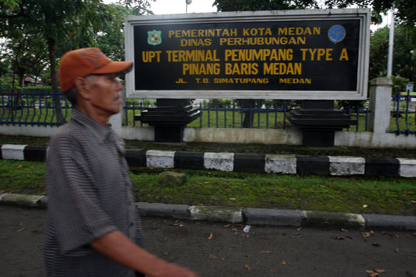 TERMINAL PINANGBARIS: Seorang warga melintas didepan Terminal Pinang Baris, Jalan TB.Simatupang Medan. Terminal ini dalam proses penyerahan aset ke pusat.