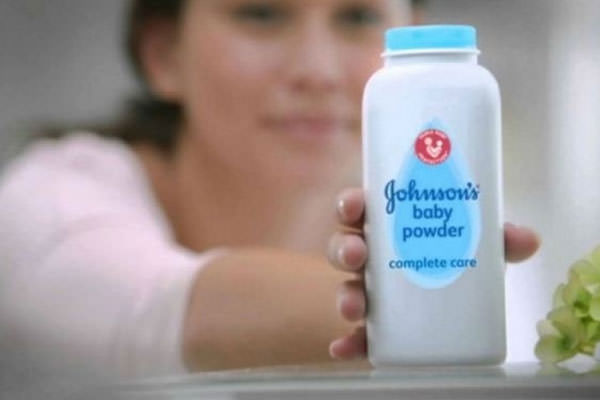 ILUSTRASI: Seorang wanita menunjukan bedak Johnson & Johnson. Di Amerika, bedak ini ditarik dari peredaran karena mengandung asbes.