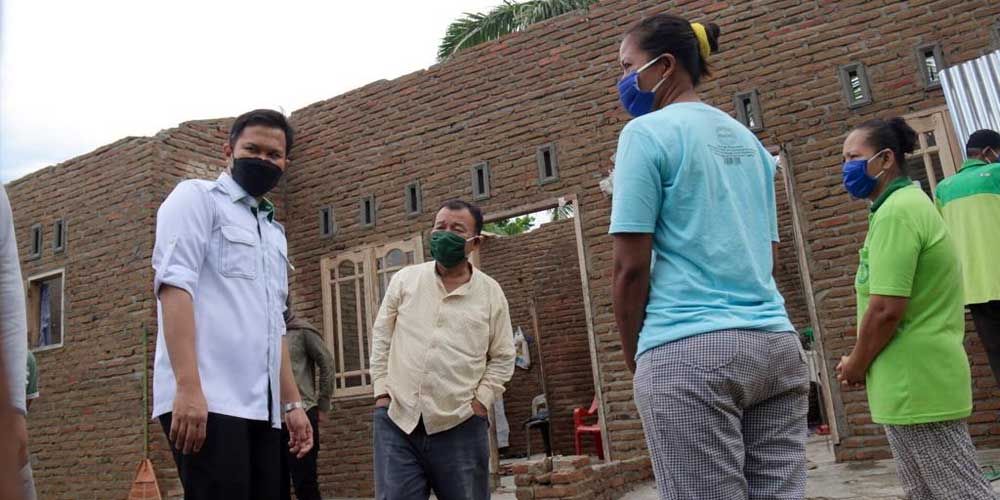 BANTUAN: Wakil Bupati Sergai, Adlin Umar Yusri Tambunan didampingi Camat Perbaungan, Muhammad Fahmi memberikan bantuan kepada warga korban angin puting beliung.sopian/sumut pos.