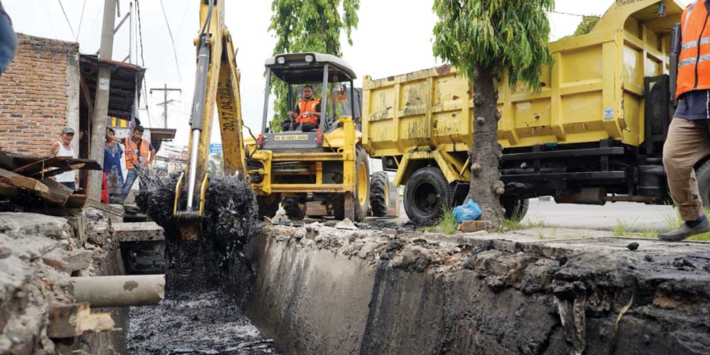NORMALISASI: Satu unit alat berat milik Dinas PU Kota Medan saat mengeruk draianse di kawasan depan pintu Tol Bandar Selamat, Selasa (24/5). Pengerukan ini dimaksudkan untuk menormalisasi drainase, dalam mengatasi banjir yang kerap terjadi di daerah terse