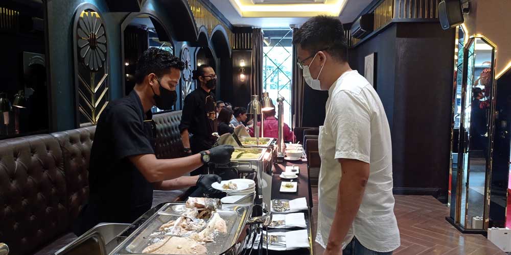 GRAND OPENING: Pegawai Le Chateau mengambilkan makanan untuk pengunjung pada acara Grand Opening di Bistronomix Jalan Perintis Kemerdekaan, Medan, Senin (16/5). m idris/sumut pos.