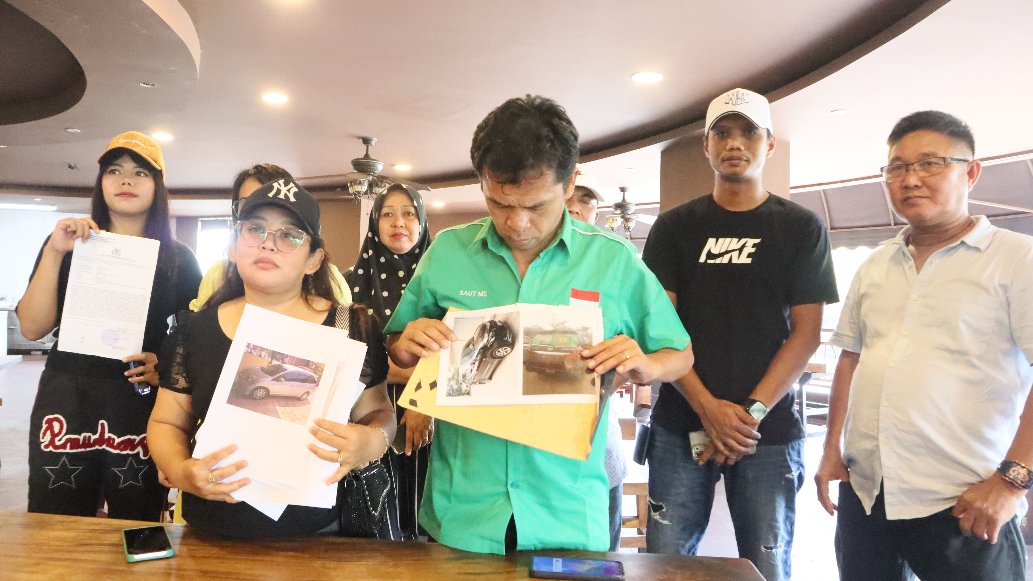 Sejumlah korban penggelapan mobil menunjukan gambar barang bukti  mobil saat memberikan keterangan di Kepri Mall, Minggu (11/8).