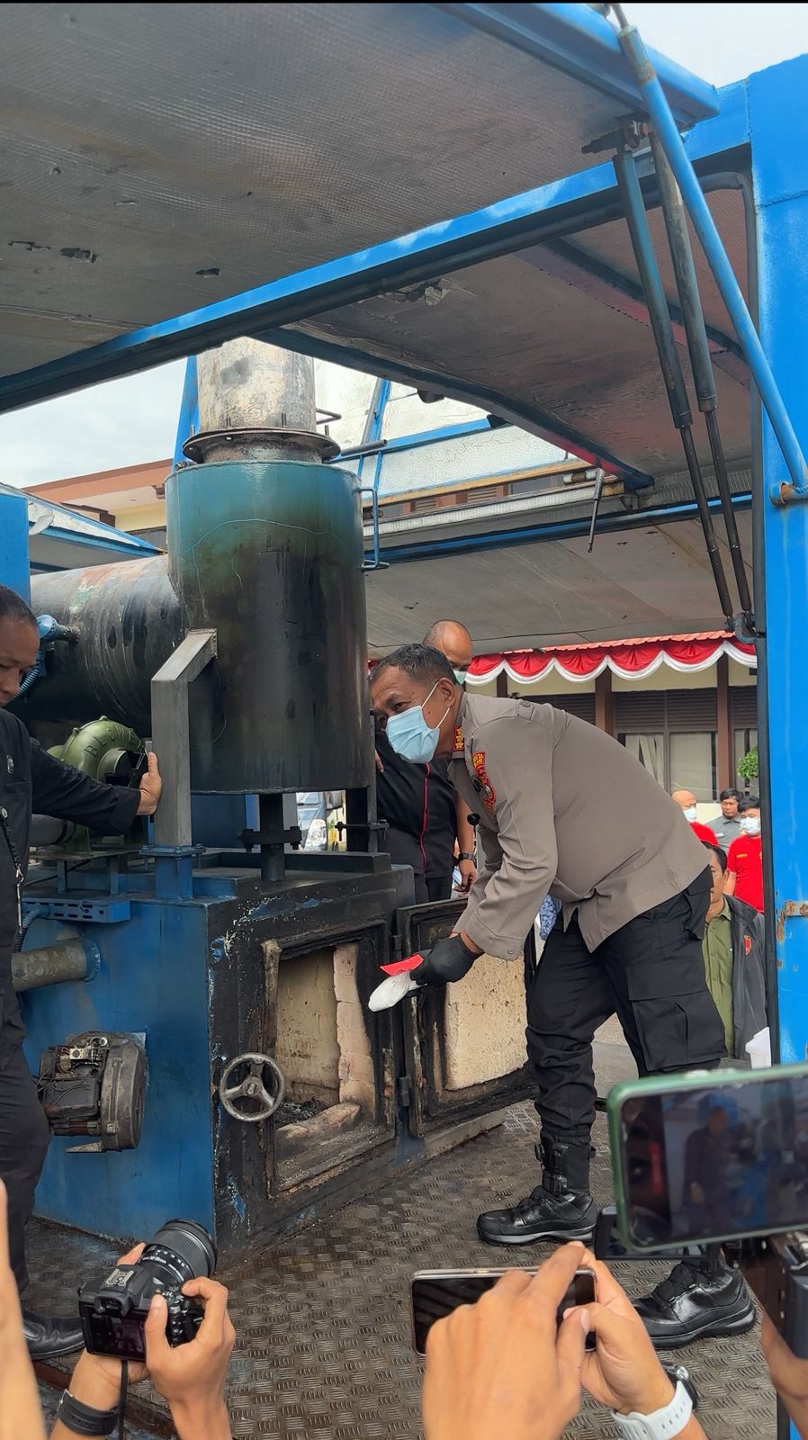 Kapolresta  Barelang memasukan narkoba ke alat pembakaran saat pemusnahan barang bukti, Jumat (11/7).
