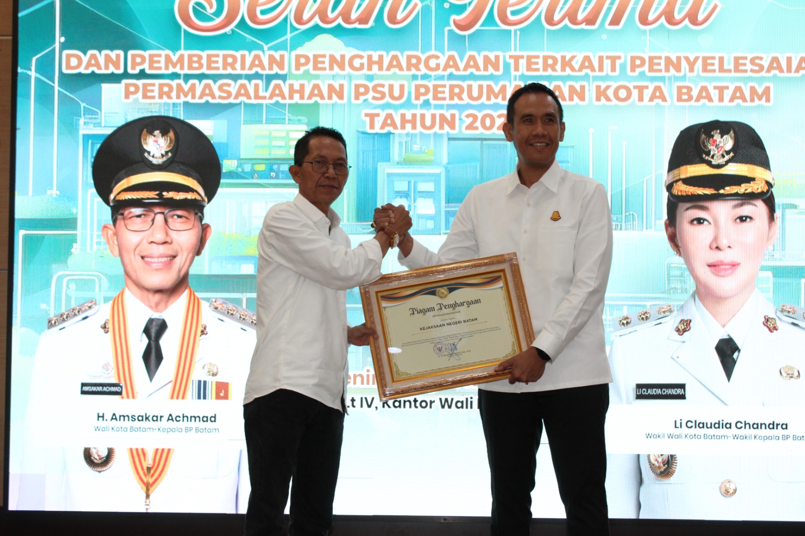 Wali Kota Batam, Amsakar Achmad, menyerahkan piagam penghargaan kepada Kajari Batam.