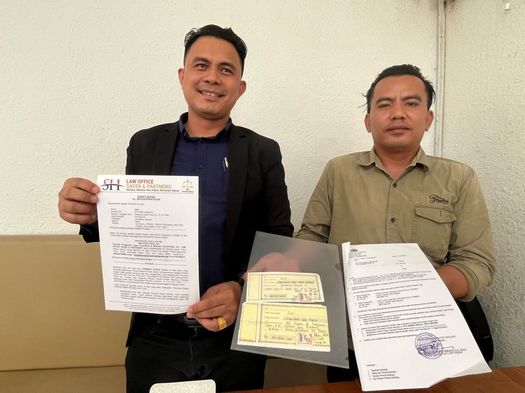Kuasa hukum menunjukkan bukti bukti dan laporan polisi.