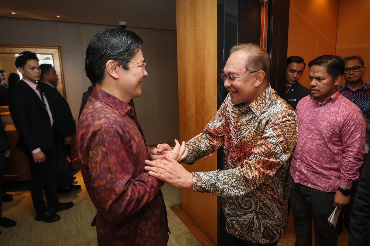 PM Singapura Lawrence Wong berjabat tangan dengan PM Malaysia Anwar Ibrahim dalam pertemuan bilateral ke-60 di Singapura, Kamis (4/12/2025)