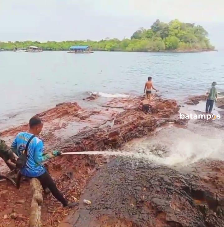 Pihak perusahaan bersama nelayan dan masyarakat setempat saat membersihkan sisa-sisa limbah yang tercecer di bibir pantai dengan menyemprotkan air sabun (Spray chemical sabun) yang terdampak minyak.