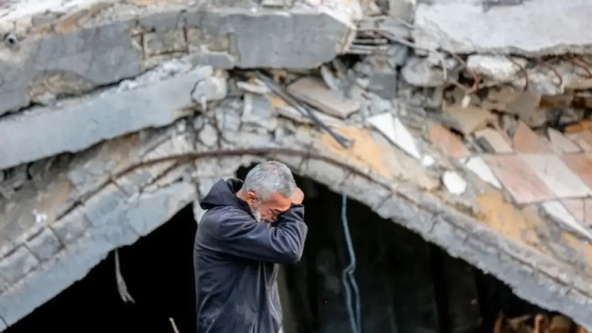 Seorang warga Palestina menangis di antara reruntuhan bangunan yang hancur akibat serangan Israel di Jalur Gaza. (Al Jazeera)
