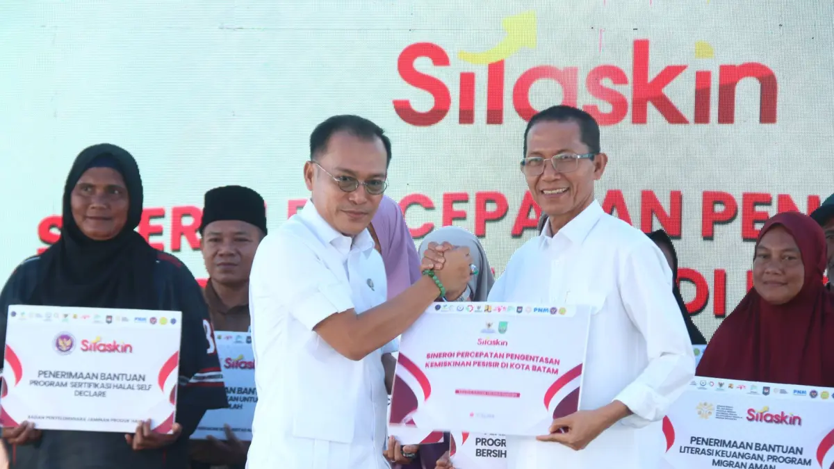 Wakil Kepala Badan Percepatan Pengentasan Kemiskinan (BP Taskin) Iwan Sumule, menyerahkan bantuan Sinergi Pengentasan Kemiskinan masyarakat pesisir kota Batam secara simbolis kepada Walikota Batam Amaakae Achmad pada acara peluncuran program  SiTaskin Pesisir (Sinergi Pengentasan Kemiskinan) di Kelurahan Sembulang, Kecamatan Galang, Selasa (7/7). F Cecep Mulyana/Batam Pos