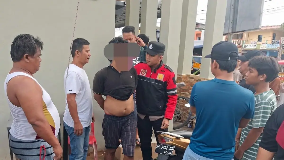 Warga Tiban Permai menyerahkan pelaku pencurian ponsel ke pihak Polsek Sekupang, Rabu (8/7/2026). F Rengga Yuliandra/Batam Pos