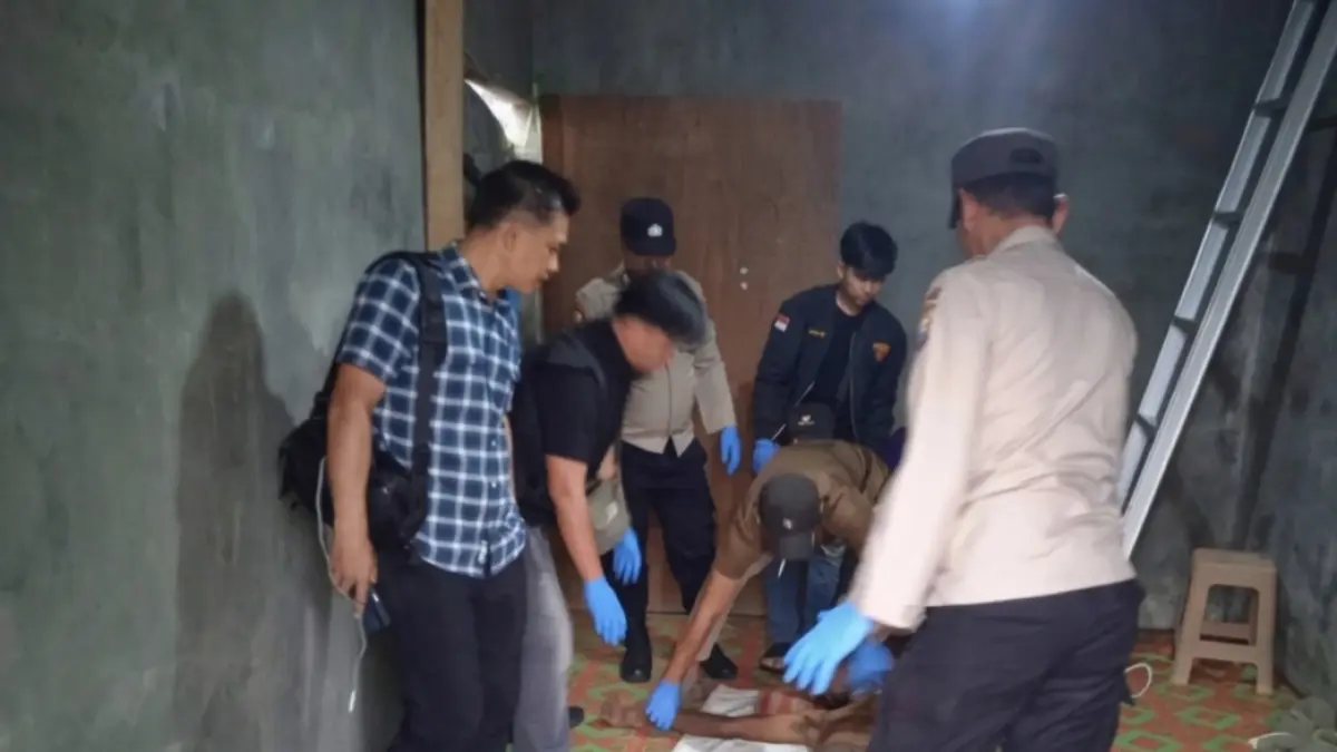 Polisi memeriksa mayat Ya yang diduga bunuh diri di dalam rumah. F. Dokumentasi Polsek Tebing