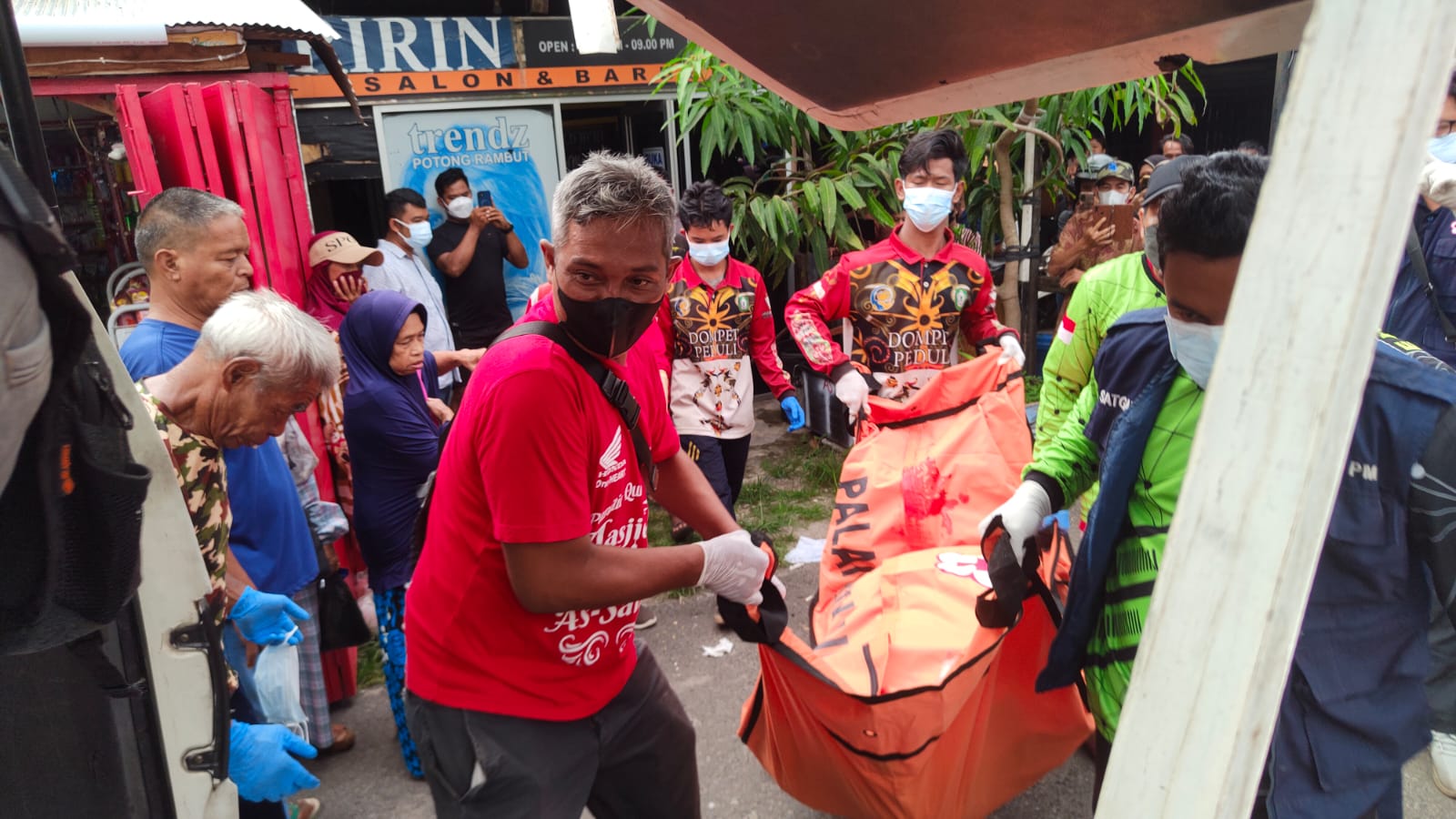 EVAKUASI: Petugas Polri dan PMI saat mengevakuasi jenazah laki-laki di Jalan Iskandar, Sampit, Selasa (13/8/2024) siang. (FAHRY/RADAR SAMPIT)