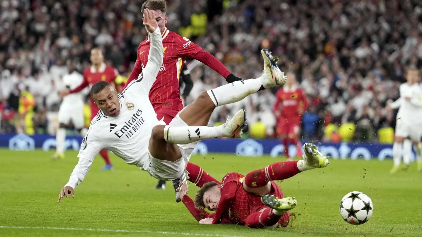 LIGA CHAMPIONS: Pemain Real Madrid Kylian Mbappe saat terkena tekel bersih dari pemain bertahan Liverpool, Kamis (28/11).