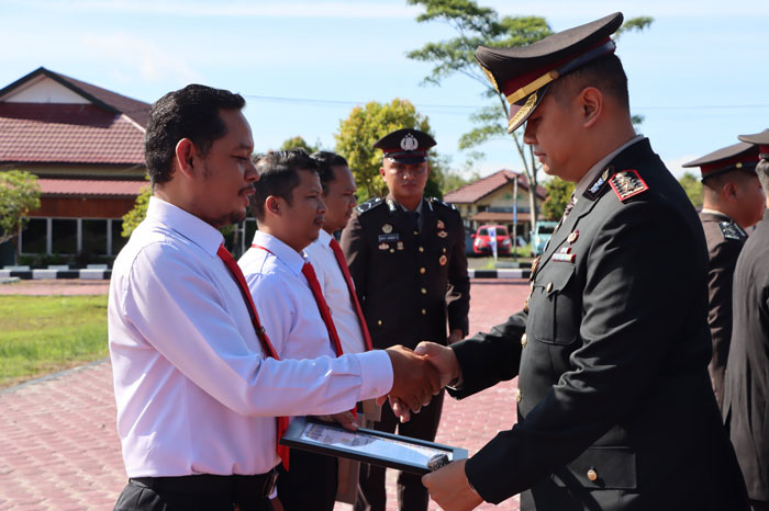 PENGHARGAAN : Kapolres Gumas AKBP Theodorus Priyo Santosa menyerahkan piagam penghargaan kepada personelnya, Kamis (19/12/2024). HUMAS POLRES GUNUNG MAS FOR RADAR SAMPIT