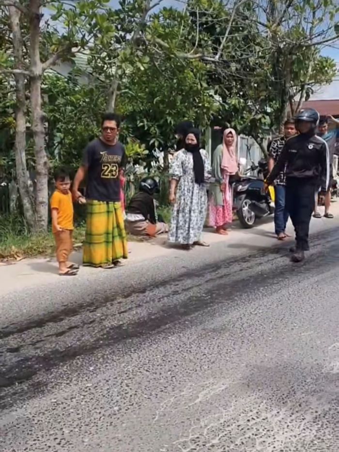 CELAKA : Pengendara nyaris tak sadarkan diri usai mengalami kecelakaan karena kendaraannya terpeleset di jalan yang terdapat ceceran solar, Jumat (4/7/2025) siang. FOTO : RADOS/RADAR SAMPIT