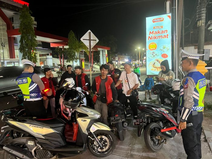 PATROLI : Personel Satlantas Polres Kotim saat menyambangi tukang ojek online di Kota Sampit, Kamis (24/7/2025) malam. //FOTO: POLRES KOTIM/RADAR SAMPIT