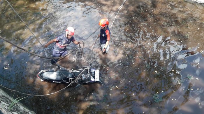 EVAKUASI : Tim Rescue Damkar Palangka Raya mengevakuasi sepeda motor pelajar SMA yang tercebur masuk sungai pengeringan di Jalan G. Obos X menuju Jalan RTA Milono, Palangka Raya, Kamis (7/8/2025).