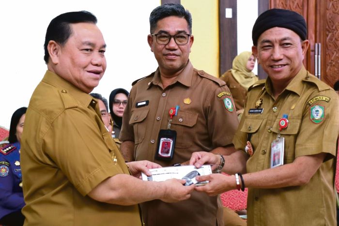 SIMBOLIS: Bupati Kotim Halikinnor menyerahkan secara simbolis kunci kendaraan dinas kepada Kepala Diskan Kotim Ahmad Sarwo Oboi, Senin (6/10/2025). FOTO: DISKOMINFO KOTIM/RADAR SAMPIT