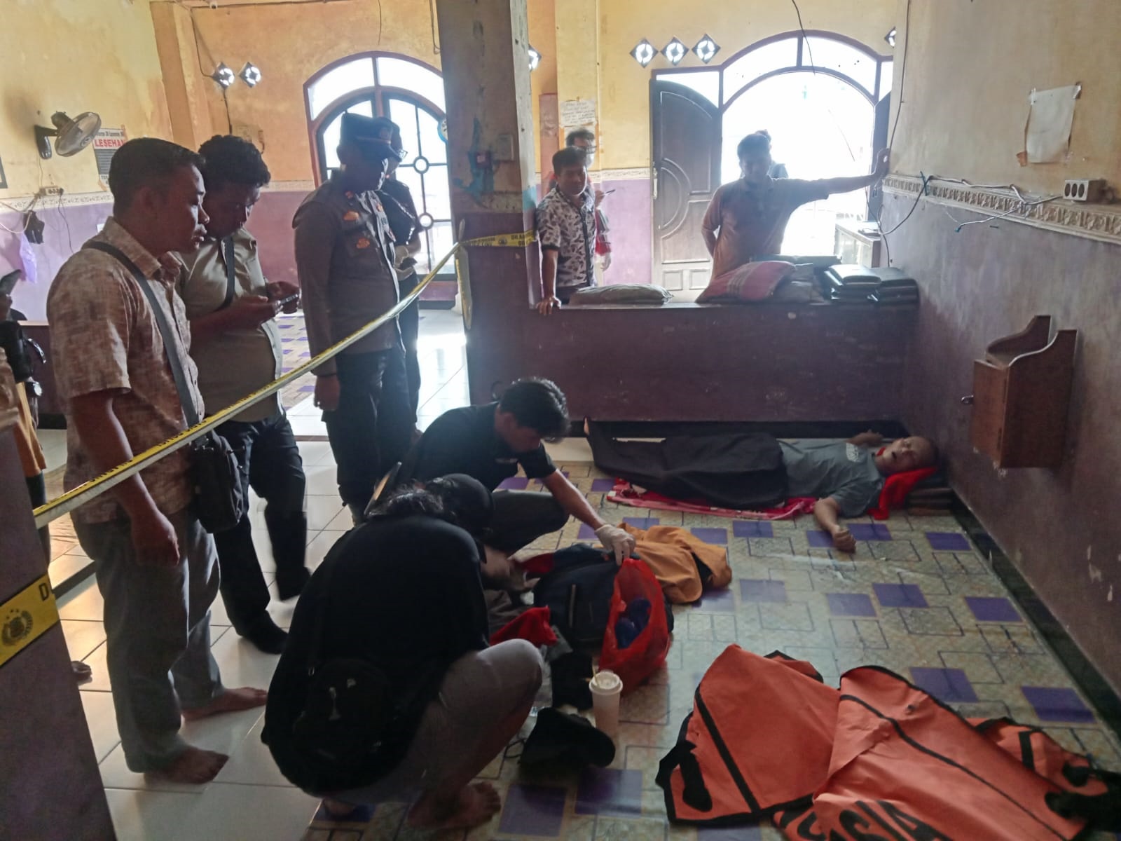 Petugas Kepolisian saat memeriksa jenazah pria yang ditemukan tergeletak di sebuah Losmen di Jalan S Parman Sampit, baru-baru tadi (12/12).