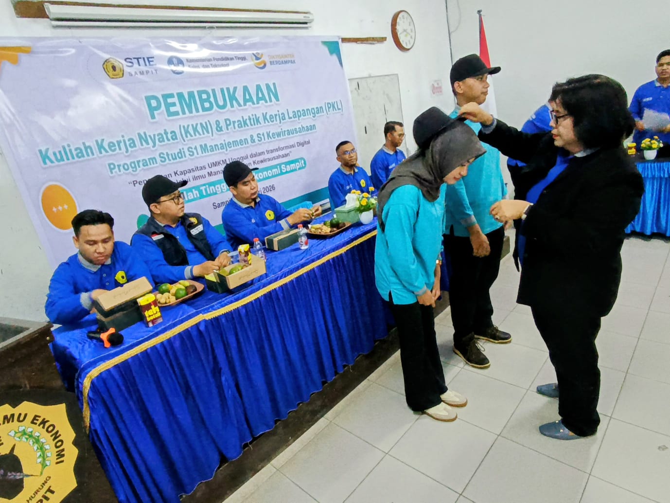 Ketua STIE Sampit Seanawati Oetama menyematkan topi kepada salah satu peserta tanda dimulainya KKN dan PKL 2026.