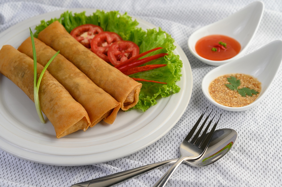 Egg roll or Fried Spring Rolls on the white plate Thai food. Selective focus.