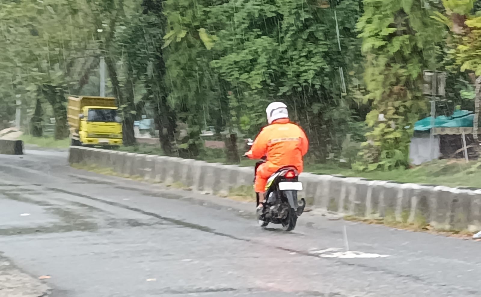 Pengendara sepeda motor menerobos rintik hujan. (Oes /Radar Sampit)