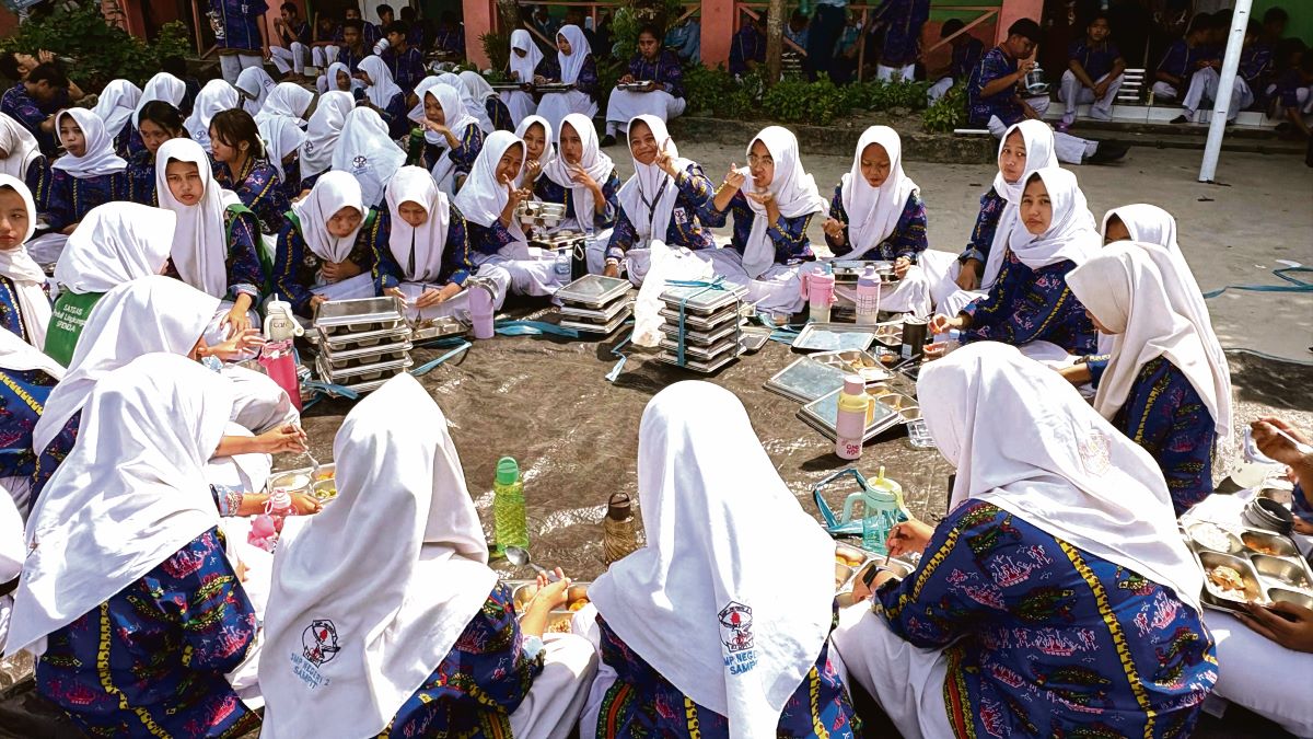 MAKAN GRATIS: Para pelajar di salah satu sekolah di Sampit menikmati makanan dari program MBG. 