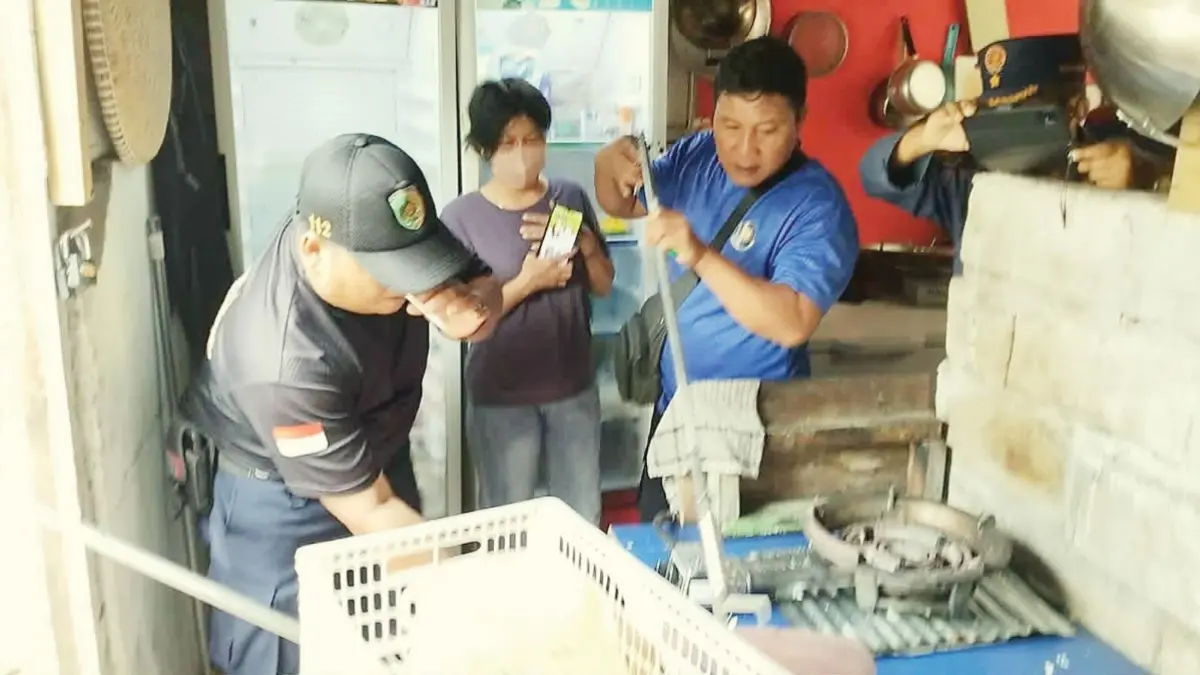 TANGKAP ULAR : Tim Rescue Damkar Kota Palangka Raya melakukan penanganan ular piton yang masuk warung milik warga, Senin (6/4/2026). FOTO: DODI/RADAR SAMPIT