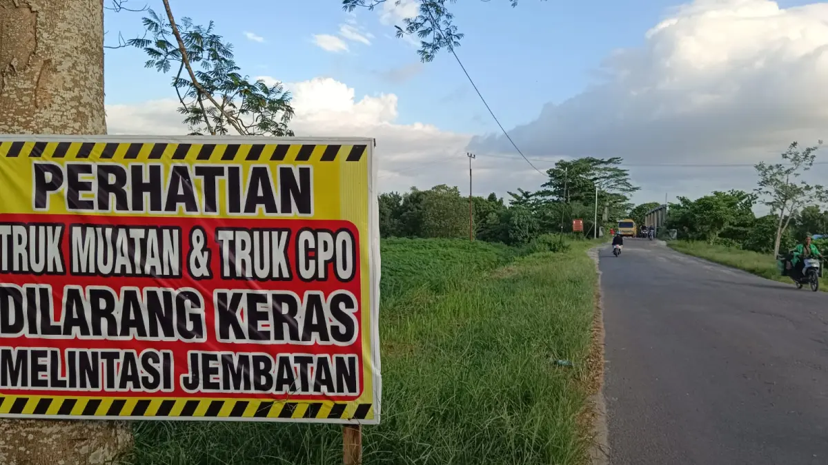 Spanduk larangan truk bermjuatan dan truk CPO melintas jembatan di Jalan Kapten Mulyono Sampit, kerap diabaikan. Puluhan truk bertonase besar tiap harinya kerap melintas dan mengancam kerusakan jembatan dan keselamatan warga. (Usay Nor Rahmad/Radar Sampit)
