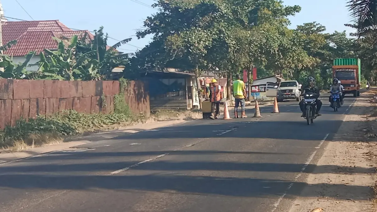 Nampak pekerja perbaikan jalan HM Arsyad, memasang rambu-rambu agar pengendara berhati-hati.(joy/radarsampit)