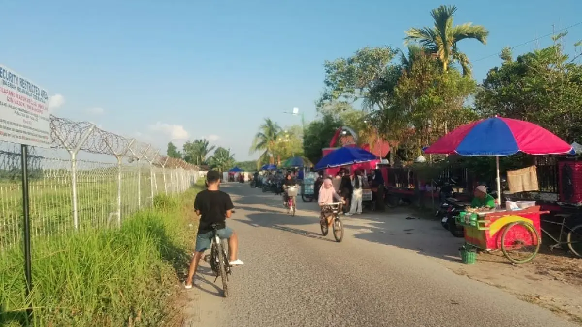 SANTAI: Warga bersantai, bersepeda dan berburu kuliner di kawasan sekitar Bandara H Asan Sampit.  FOTO: ALFIAN ARWI PERMANA/RADAR SAMPIT