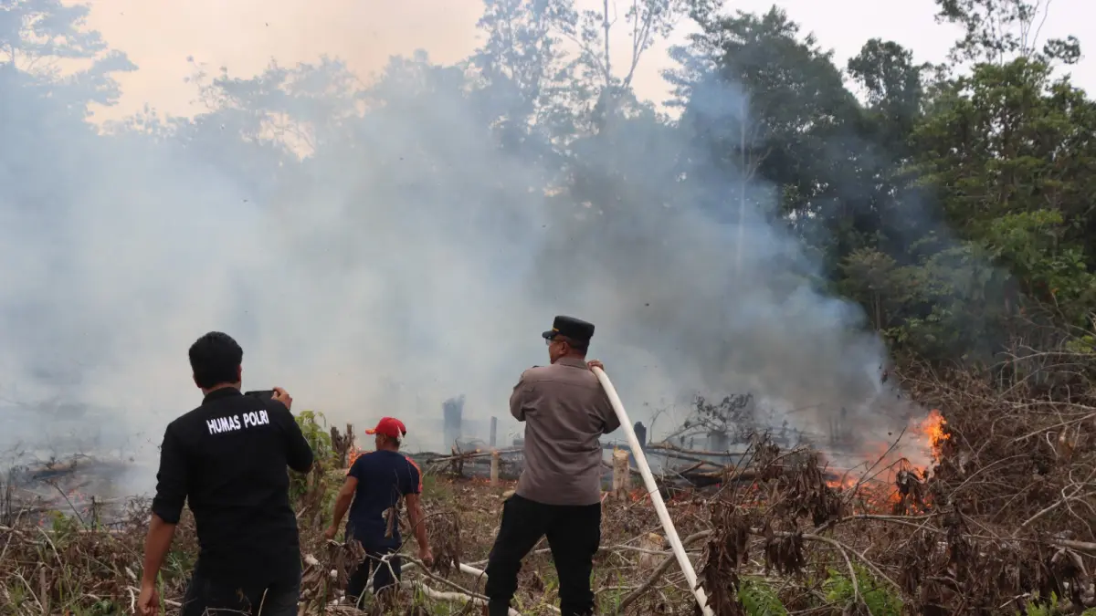 Tim gabungan berupaya padamkan api yang membakar lahan, di perbatasan Desa Sarerangan dan Tumbang Pajangei, Kecamatan Tewah, Sabtu (15/8).(istimewa/Humas Polres Gumas)