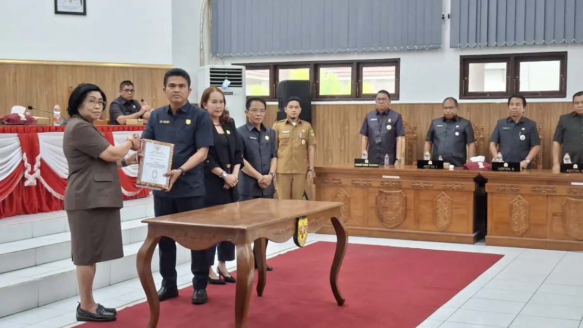 Wakil Bupati Gumas Efrensia LP Umbing menyerahkan dokumen nota keuangan tentang rancangan perubahan APBD 2026 kepada Ketua DPRD Binartha pada rapat paripurna ke-1 masa persidangan 1 tahun sidang 2026, Senin (24/8). (DISKOMINFO SANTIK FOR RADAR SAMPIT)