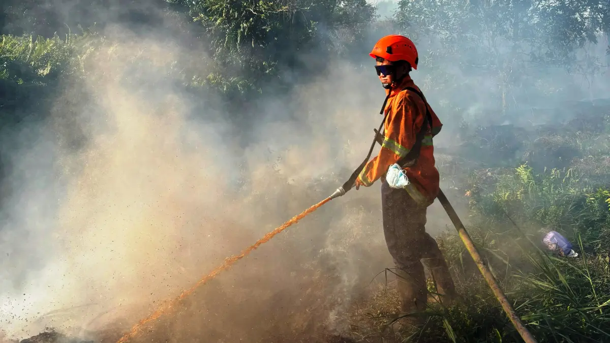 BERANI: Salah satu aksi Adam, saat ikut turun memadamkan lahan yang terbakar.(istimewa/dok/relawan)