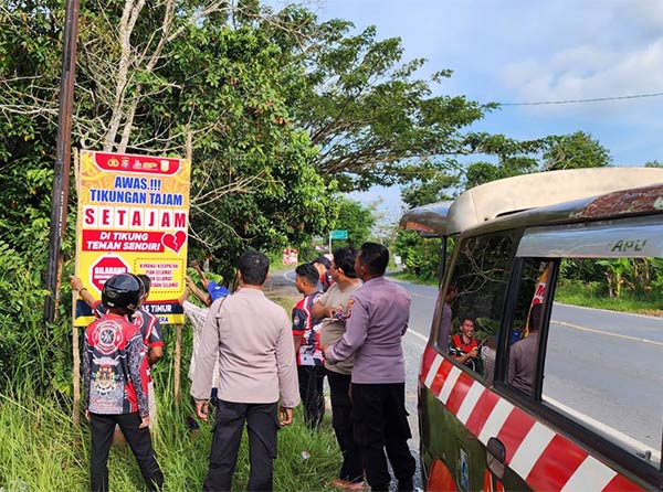 CEGAH LAKALANTAS: Personel Polsek Kapuas Timur dipimpin Kapolsek Kapuas Timur memasang himbauan antisipasi kecelakaan di Jalan Trans Kalimantan kecamatan Kapuas Timur. (ALEXANDER/RADAR SAMPIT)