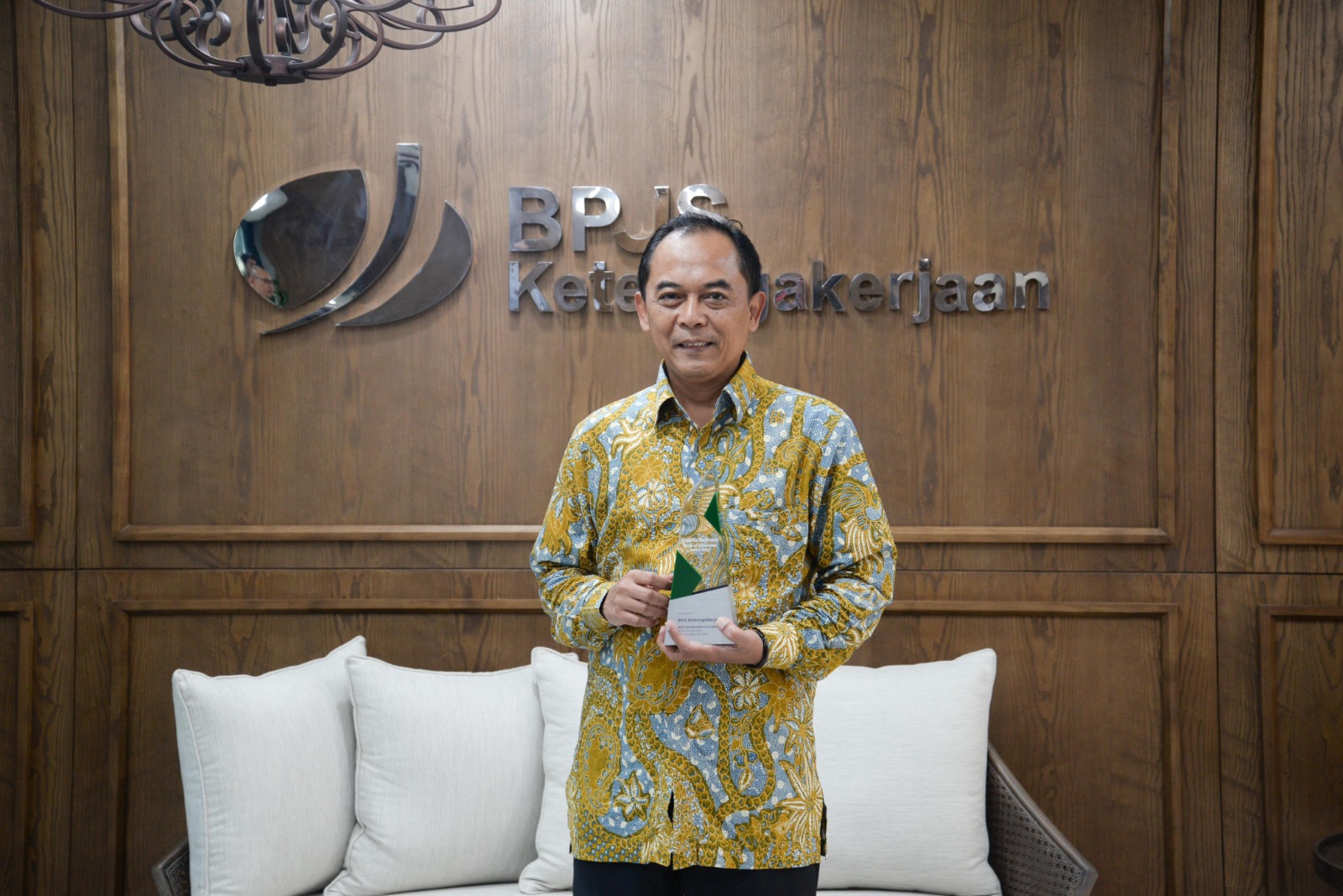 Direktur Umum dan SDM BPJS Ketenagakerjaan, Abdur Rahman Irsyadi saat menerima piala penghargaan Best Nation Wide Collaboration pada ajang Grab Business Forum 2024.