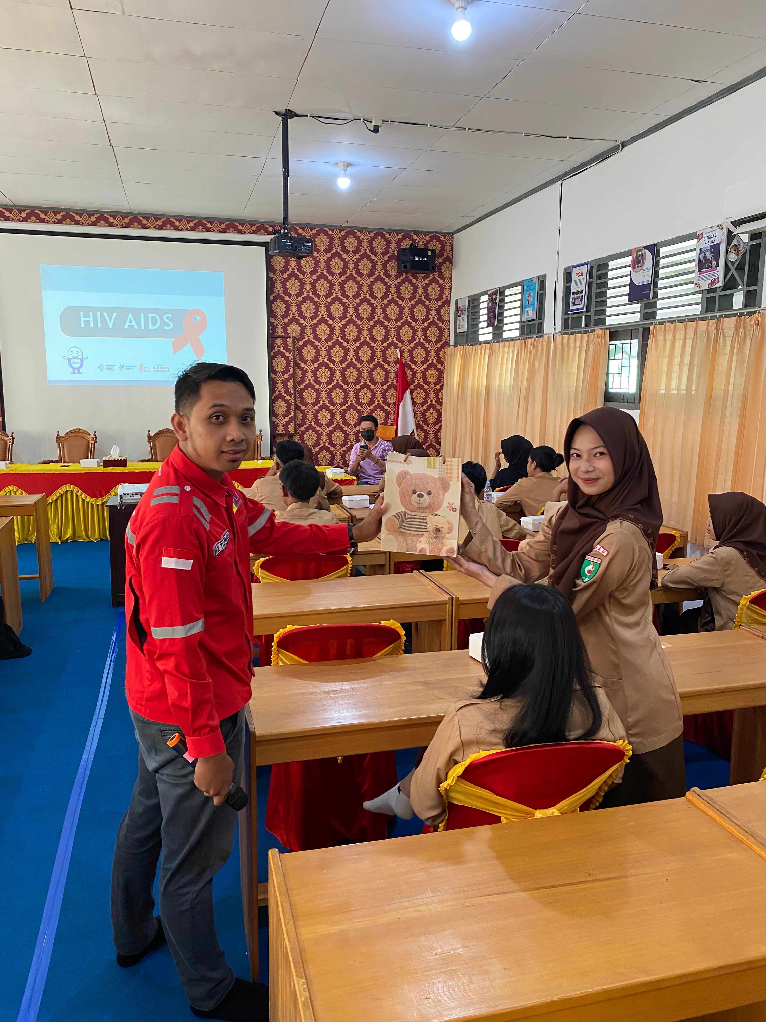 INTERAKTIF: Team Leader K3L dan Keamanan Unit Layanan PLTD Tanjung Selor Adi Tiarahman saat memberikan souvenir ke peserta saat sosialisasi berlangsung di SMAN 4 Berau. (PLN NP UP KALTIMRA UNTUK BP)