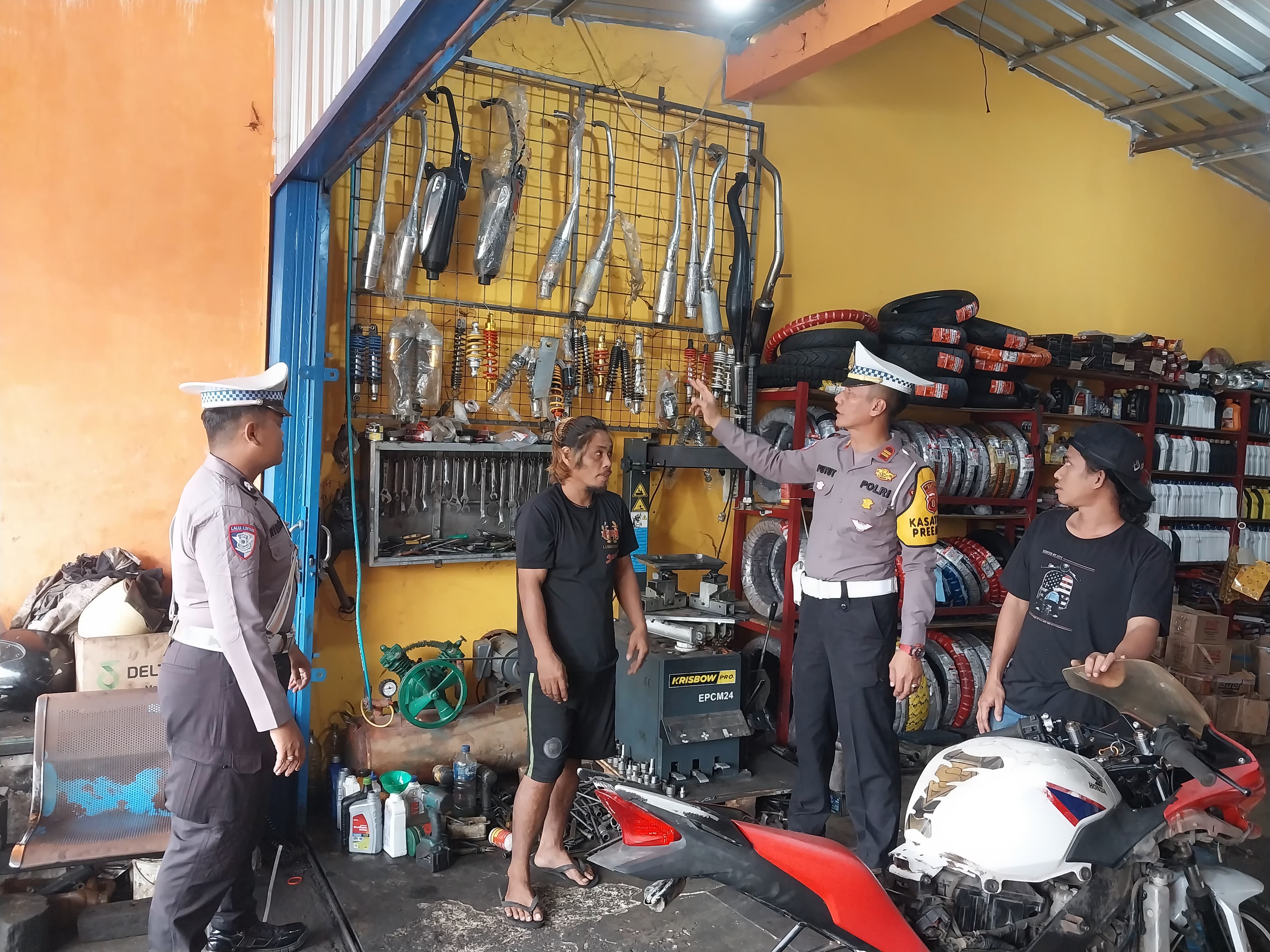 BERI EDUKASI: Jajaran Satlantas Polres Berau saat memberikan arahan terkait larangan pemakaian maupun menjual knalpot brong kepada pemilik usaha bengkel. (ARTA KUSUMA YUNANDA/BP)