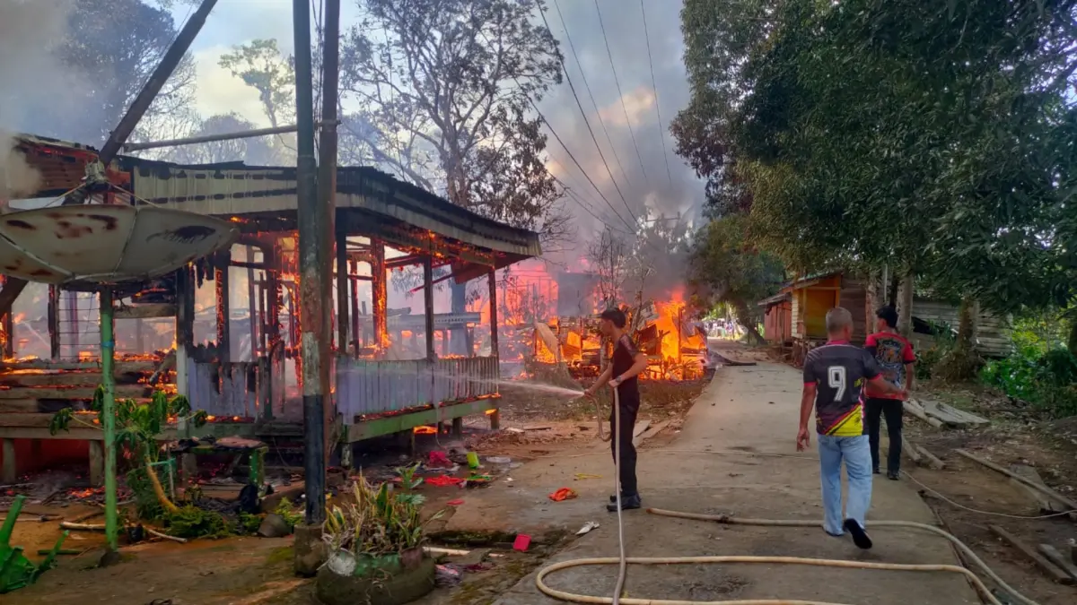 BERJIBAKU: Petugas pemadam kebakaran berupaya memadamkan api yang menghanguskan rumah warga di Desa Sekatak Buji, Kecamatan Sekatak. (POLRESTA BULUNGAN)