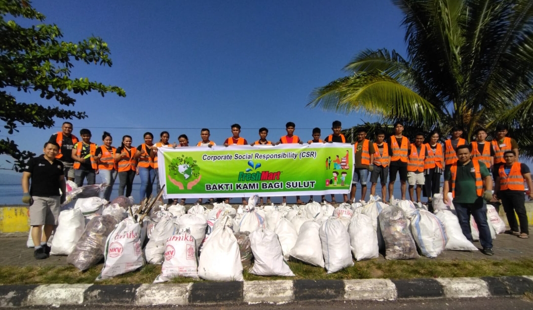 Peduli Lingkungan Fresh Mart berhasil angkat sampah sebanyak 100 karung dari Pantai Tuminting. Ikut turun CEO Fresh Mart Andy Sumual (kaos hitam kiri)