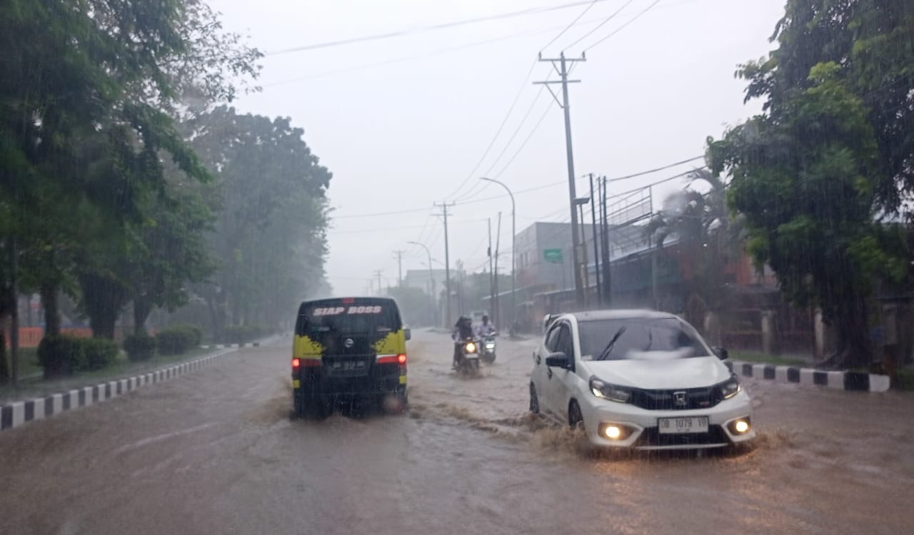 Kondisi ruas jalan depan Gudang Bulog, Kelurahan Paceda, Kecamatan Madidir, Kota Bitung saat hujan deras.(Franky Sumaraw/MP)