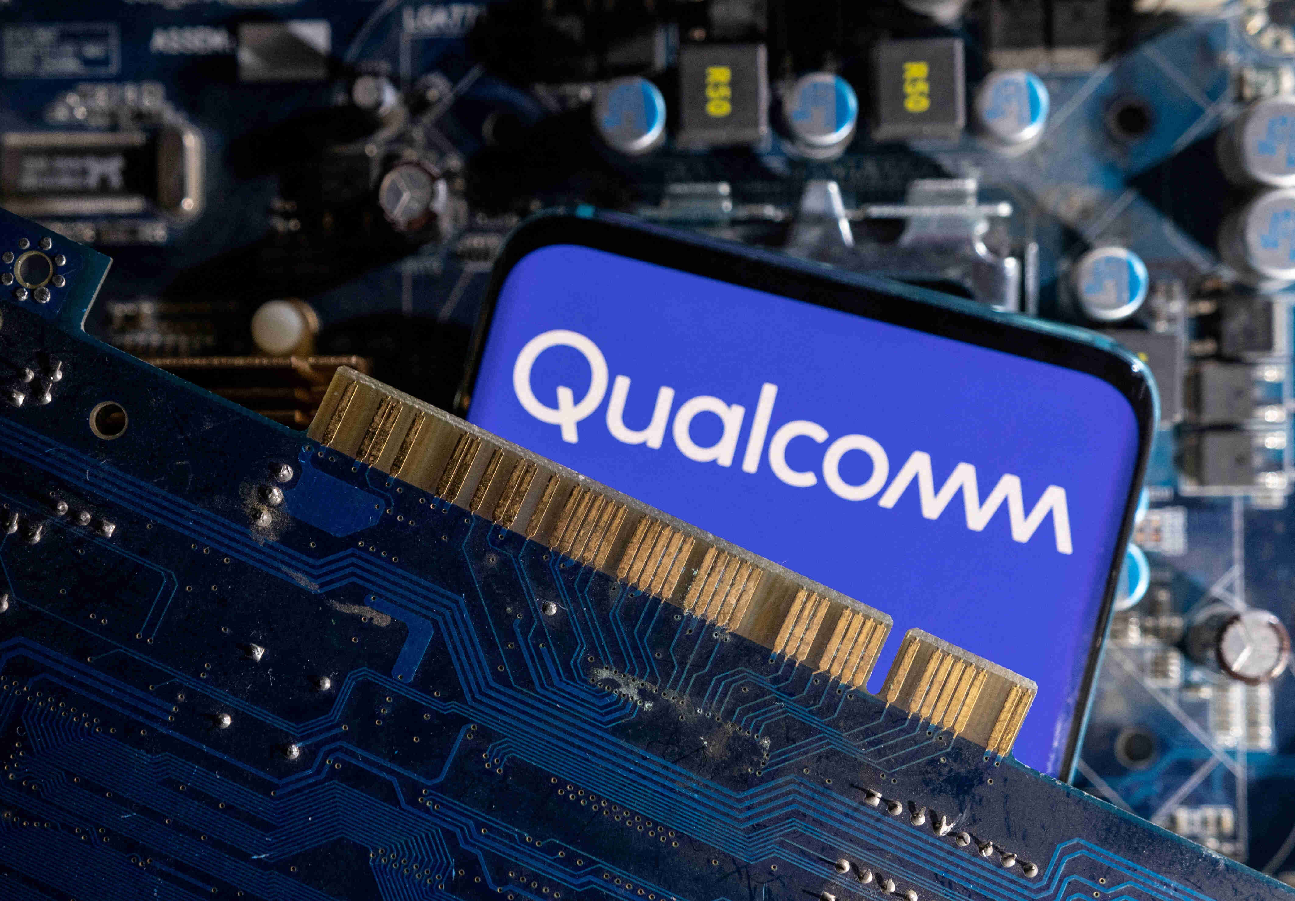 FILE PHOTO: A smartphone with a displayed Qualcomm logo is placed on a computer motherboard in this illustration taken March 6, 2023. REUTERS/Dado Ruvic/Illustration/File Photo