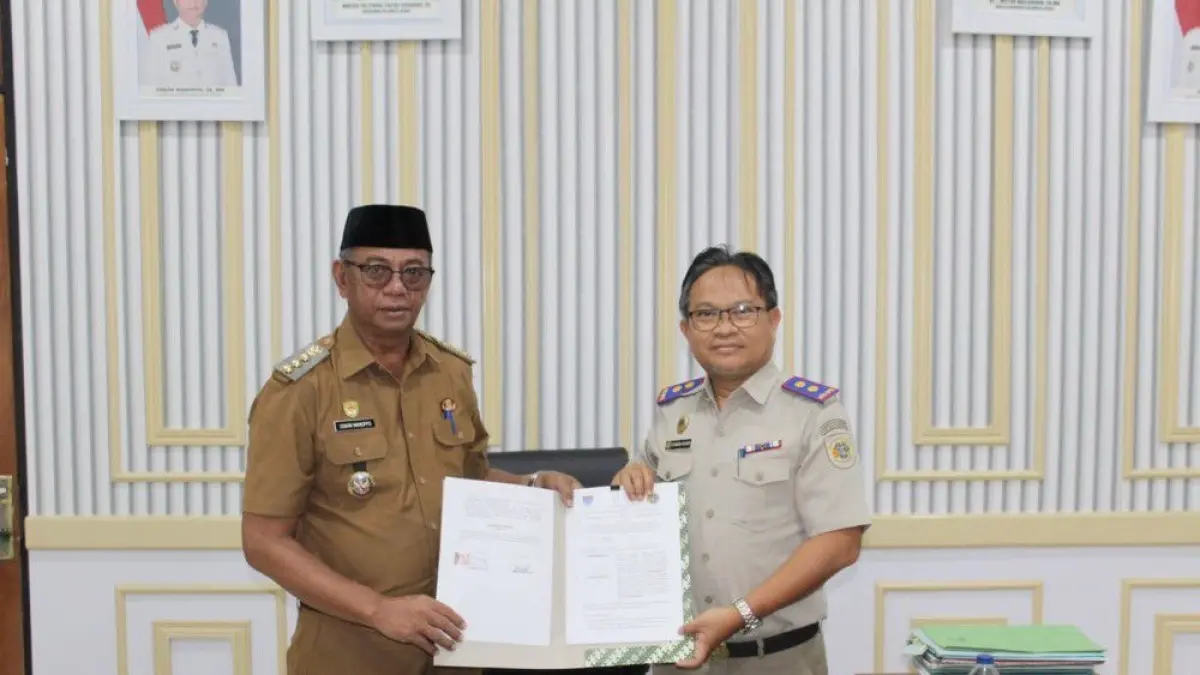 Penandatanganan Perjanjian Kerja Sama antara Bupati Boltim Oskar Manoppo, dan Kepala Kantor Pertanahan Boltim Candra Husain, Senin (18/5).