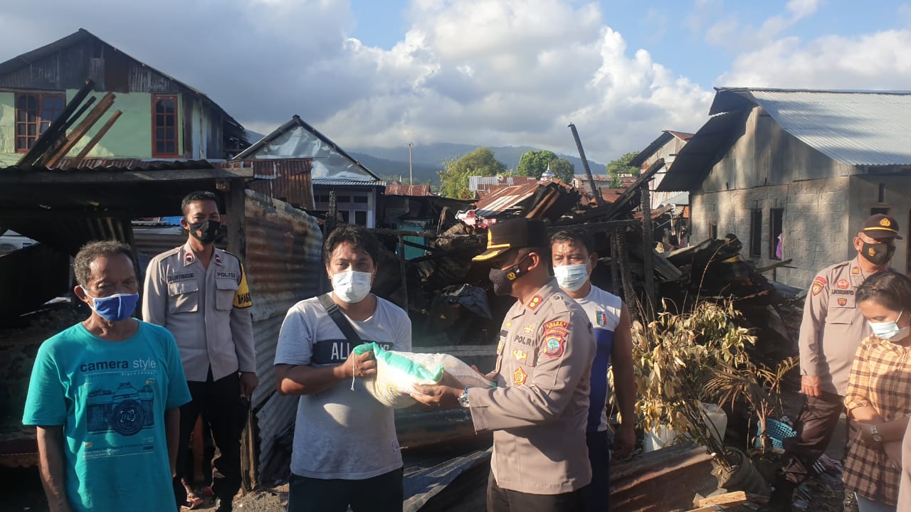 Kapolres Bitung AKBP Alam Kusuma S Irawan menyerahkan bantuan kepada korban bencana kebakaran di Kelurahan Bitung Timur, kompleks Sari Kelapa.(Humas Polres Bitung)
