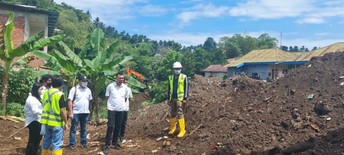 DIANGKAT DARI SUNGAI: Kepala Satker OP-SDA Balai Wilayah Sungai Sulawesi I Iskandar Rahim dan tim saat melakukan pemantauan pekerjaan pengerukan Sungai Tikala. Tampak tumpukan sedimen usai diangkat dari DAS Tikala di Kelurahan Perkamil.